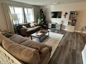 Living room with dark hardwood / wood-style floors