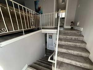 Stairway featuring hardwood / wood-style flooring