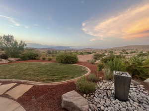 Yard at dusk with a mountain view