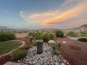 Yard at dusk featuring a mountain view