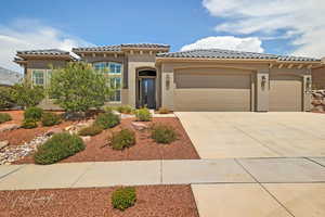 Mediterranean / spanish-style home with a garage