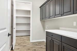 Laundry area featuring cabinets, washer hookup, and light wood-type flooring