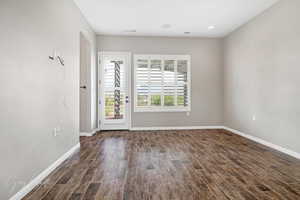 Unfurnished room featuring dark hardwood / wood-style flooring