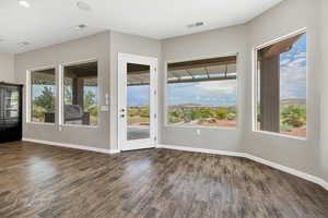 Doorway to outside with dark hardwood / wood-style flooring