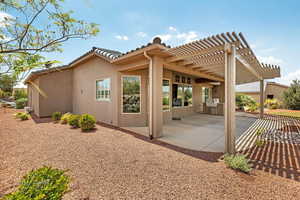 View of property exterior with a pergola and a patio area