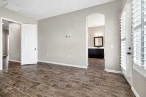 Unfurnished bedroom featuring sink and ensuite bath