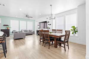 Dining space with plenty of natural light, light hardwood / wood-style floors, and a textured ceiling