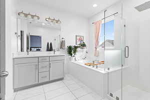 Bathroom with vanity, tile patterned flooring, and shower with separate bathtub