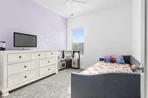 Carpeted bedroom with ceiling fan