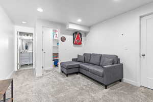 Carpeted living room with sink