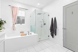 Bathroom featuring shower with separate bathtub