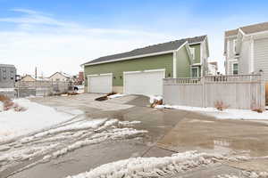 View of snowy exterior featuring a garage