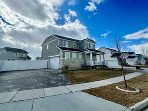 View of front of home with a garage and a front yard