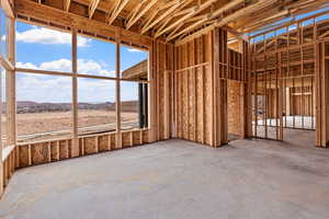 Misc room with concrete flooring and a mountain view