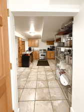 Kitchen with stainless steel range and light tile patterned floors