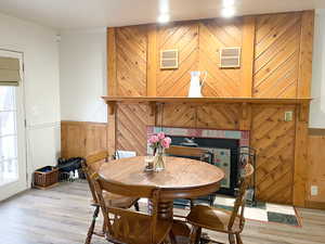 Dining space featuring hardwood / wood-style floors, crown molding, and a healthy amount of sunlight