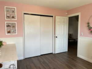 Unfurnished bedroom featuring dark hardwood / wood-style floors and a closet