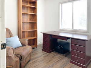 Home office with light hardwood / wood-style flooring