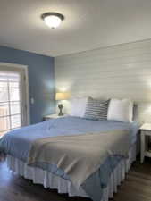 Bedroom with dark wood-type flooring