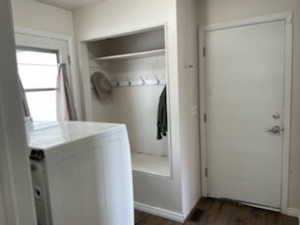 Laundry area featuring dark wood-type flooring and washing machine and dryer