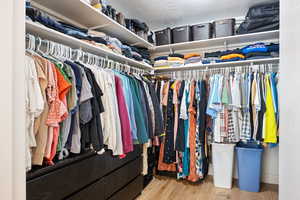 Walk in closet featuring hardwood / wood-style floors