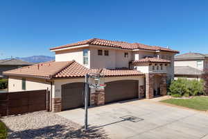 Mediterranean / spanish-style house featuring a garage and a mountain view