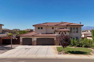 Mediterranean / spanish-style home with a garage and a mountain view