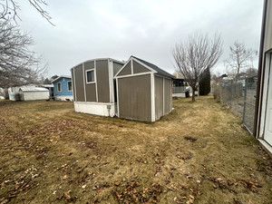 View of outbuilding featuring a yard