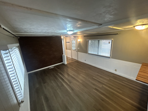 Unfurnished room featuring dark wood-type flooring