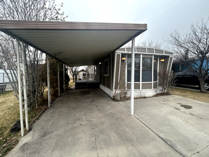 View of parking with a carport