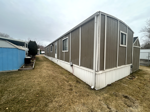 View of property exterior with a yard