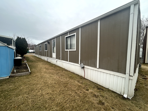 View of side of property with a yard