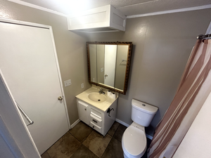 Bathroom with vanity, tile patterned flooring, and toilet