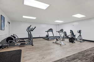 Workout area featuring light wood-type flooring