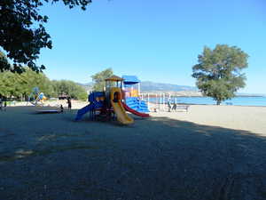 View of jungle gym with a water and mountain view