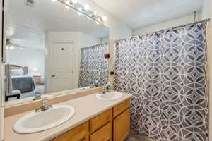 Bathroom with vanity and ceiling fan