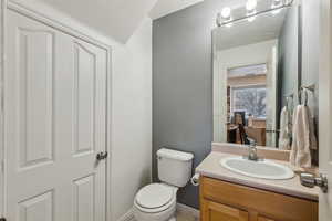 Office bathroom with vanity and toilet