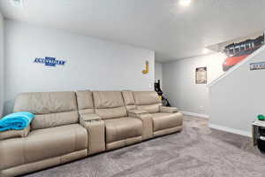 Living room featuring carpet floors and a textured ceiling