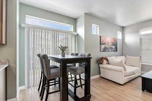 Dining room featuring light wood-style laminate floors and sliding glass door to small deck