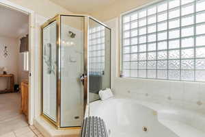 Bathroom with shower with separate bathtub and plenty of natural light