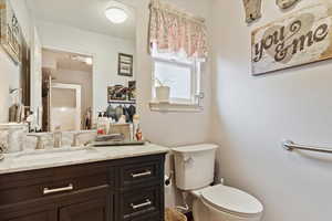 Bathroom featuring vanity and toilet