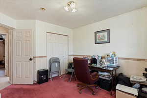 Office featuring a textured ceiling and carpet flooring