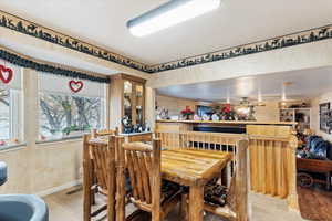 Dining room featuring indoor bar, plenty of natural light, and light wood-type flooring