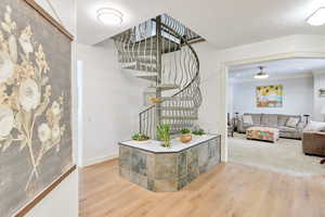 Interior space with ceiling fan and hardwood / wood-style floors