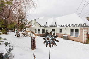 Snow covered property with cooling unit