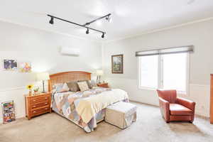 Casita -Carpeted bedroom with a wall mounted air conditioner