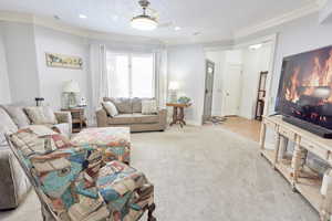 Living room featuring light carpet and crown molding