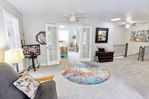 Sitting room with carpet floors and french doors