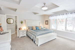 Bedroom with light carpet, a tray ceiling, ornamental molding, and a textured ceiling