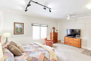 Casita - Bedroom featuring crown molding, light colored carpet, and ceiling fan